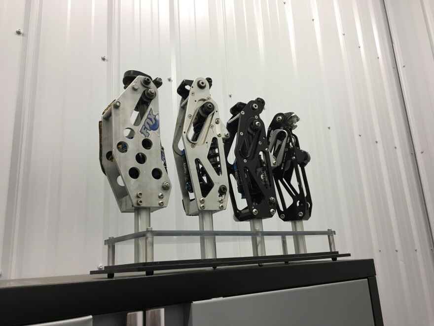 Some of the early versions of the Moto Knee on display in one of Mike Schultz's work rooms. The part, used in a prosthetic sports leg, is based on a mountain bike shock absorber. Schultz, a U.S. Paralympic snowboarder, invented the Moto Knee, as well as the Versa Foot, after his leg was amputated following a snowmobile race accident in 2008.