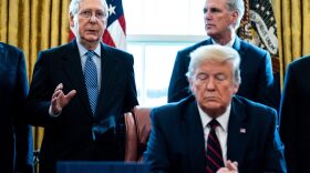 Senate Majority Leader Mitch McConnell (R-KY) speaks as House Minority Leader Kevin McCarthy (R-CA) U.S. President Donald Trump listen during a signing ceremony for H.R. 748, the CARES Act in the Oval Office of the White House  in Washington, DC.