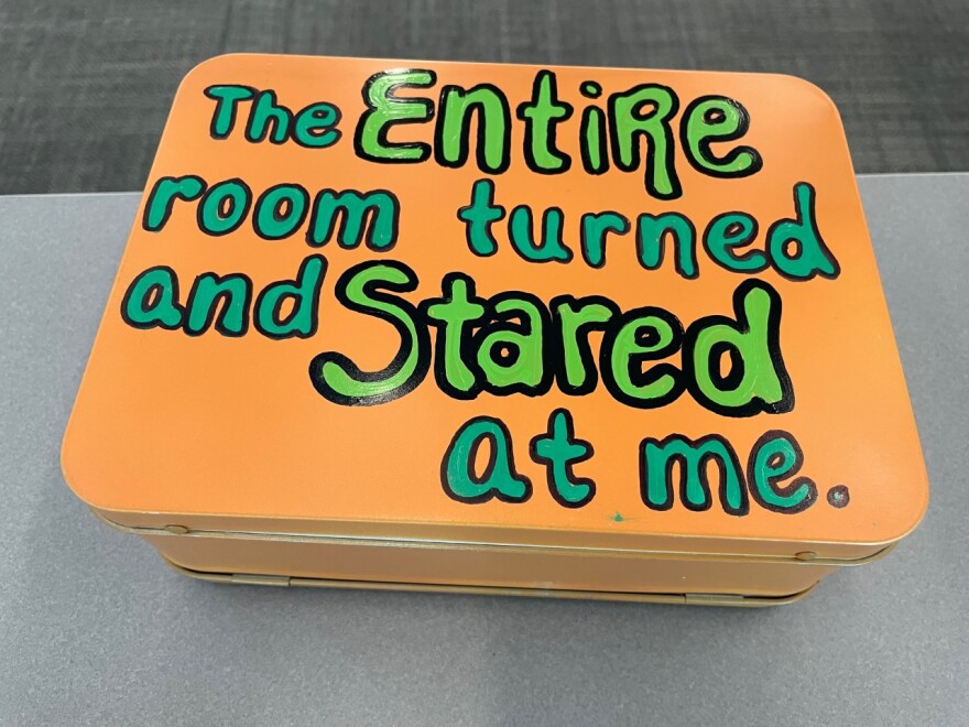 A "Lunchbox Moments" exhibit lunchbox reads, "The entire room turned and stared at me."