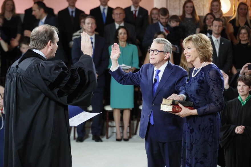 Gov. Mike DeWine takes the oath of office during his Inauguration Ceremony in the Statehouse Rotunda. The oath was administered by his son, Ohio Supreme Court Justice Pat DeWine.