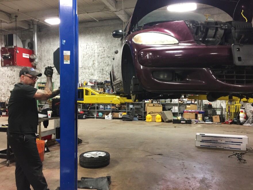 Nick Kuespert works the car lift at the Vehicles for Change shop in Baltimore.