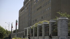 Police officers run to take position around Iran's parliament building in Tehran after an assault by several attackers. Four attackers reportedly reached the building's interior, and an explosion was heard, although it was unclear whether it was a suicide bomb or a grenade.