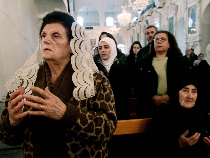 Syrian Christians and Muslims at the Greek Orthodox Mariamiya Church in Damascus offer prayers for Greek Orthodox nuns who left their convent in Maaloula with rebels amid heavy fighting.