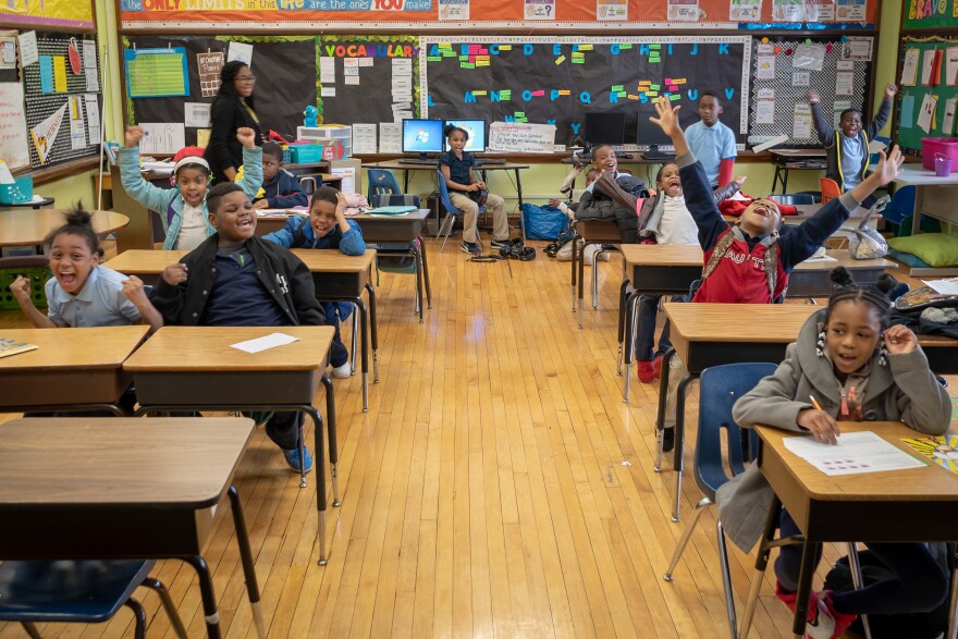 Second-graders at Bryan Hill Elementary School react to having their class announced over the intercom for having perfect attendance. The north St. Louis school has the second-best attendance in the district.