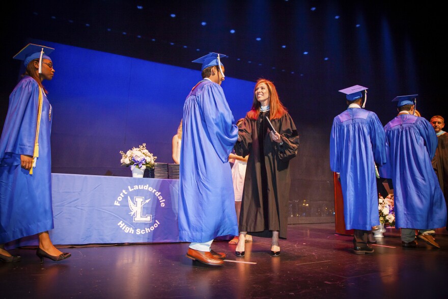 Sam crosses the stage to accept his diploma during his high school graduation at the Broward Center for the Performing Arts in Fort Lauderdale.