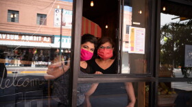 Vanessa Zubia-Meza and her mother Margie Zubia are pictured in the window of their new restaurant called El Paseo on May 18, 2020 in downtown El Paso, Texas. (PAUL RATJE/AFP via Getty Images)