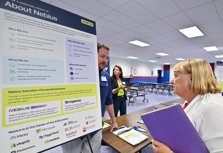 Duggan O'Dea talks with a Schuylkill County resident about Nebius at North Schuylkill High School.