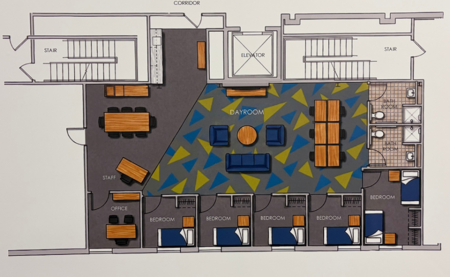 A picture of a blueprint and prototype for the Daybreak youth shelter renovation.