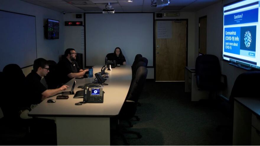 Emergency Management Coordinators Conor Bake (left), Taylor Jones and Catherine Hughes listen to a webinar presented by Division Director Don Campbell from his office in Greensboro during the response to the COVID-19 pandemic on Thursday, May 14.