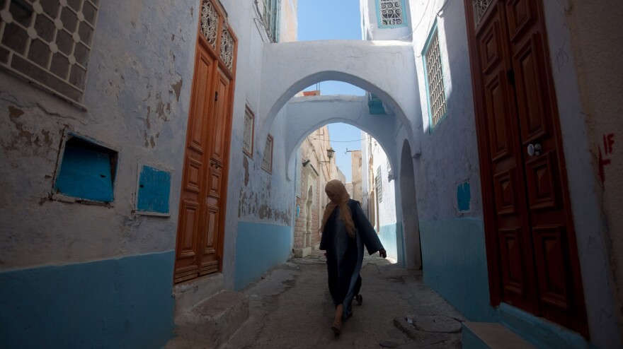 A woman walks the narrow streets of the old city in Kairouan, Tunisia.