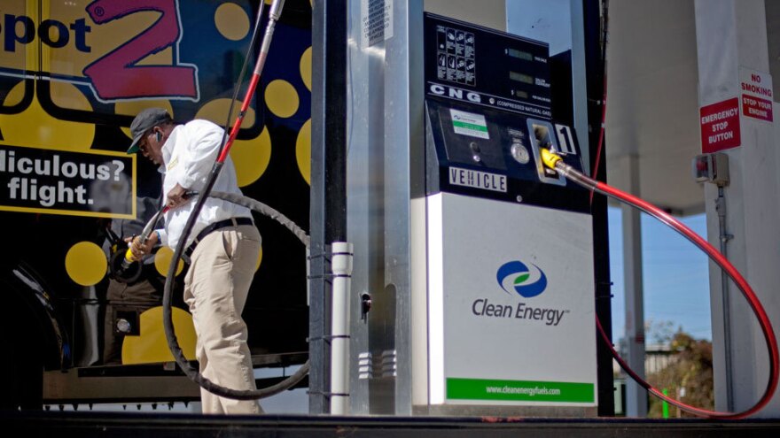 Bob Davis fills up his airport shuttle van at a natural gas pumping station in College Park, Ga. A growing number of companies are considering converting their vehicle fleets to natural gas.