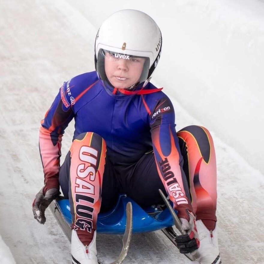 a child in a helmet on a small sled