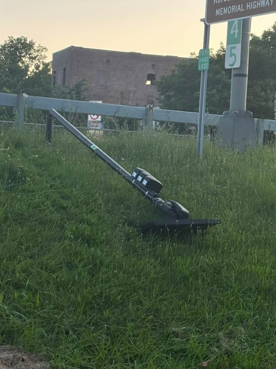 A Flock camera that’s been knocked down