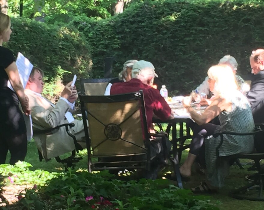 "A Prairie Home Companion" host Garrison Keillor (left) meets with his staff prior to a live performance of the show at Tanglewood in Lenox, Massachusetts on June 25, 2016. (Robin Young/Here & Now)