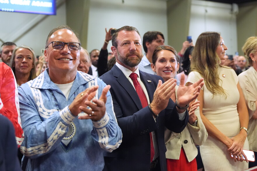 Choctaw Nation Chief Gary Batton, Homeland Security Secretary Markwayne Mullin (center) and others listen as President Donald Trump speaks at a campaign rally at the Choctaw Event Center, Thursday, Oct. 1, 2026, in Durant, Okla.