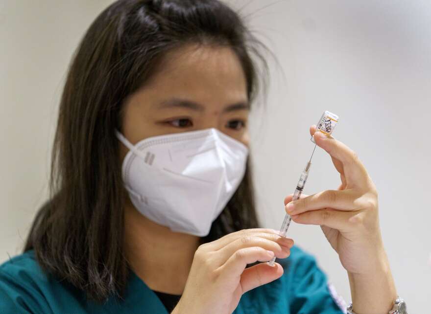 In this OPB file photo, Clackamas Community College nursing student Nina Tan draws up doses at a pediatric COVID-19 vaccine clinic held at Clackamas Town Center, Nov. 10, 2021 in Happy Valley, Ore. Booster shots are now approved for everyone older than five.