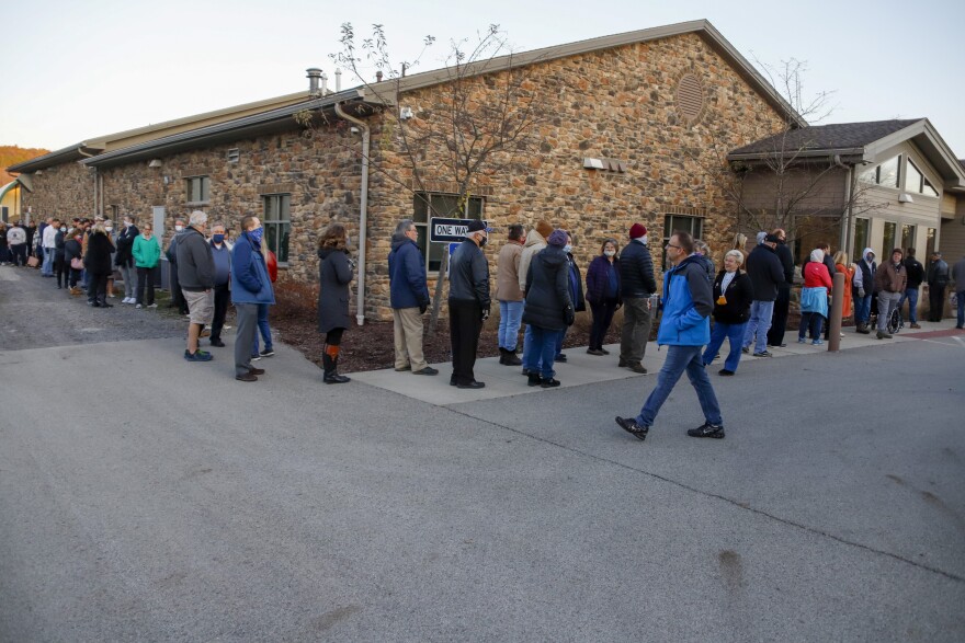 People line up completely surrounding the Jackson Township Municipal Building, in three separate lines alphabetically by last name, as the poll opened, Tuesday, Nov. 3, 2020, Election Day, in Jackson Township, Pa.