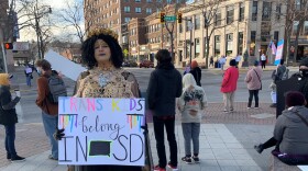 Cynthia Grace stands at the corner of 6th and Main St. in Rapid City at the Protect Trans Kids Rally in January