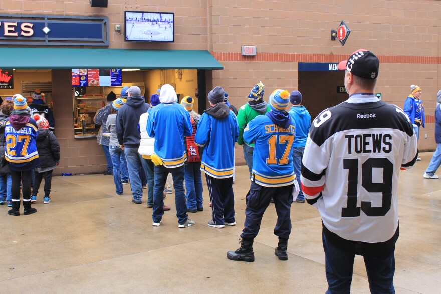 Some of the sellout Winter Classic crowd waiting in line for food while keeping an eye on the game at Busch Stadium on Jan. 2, 2017