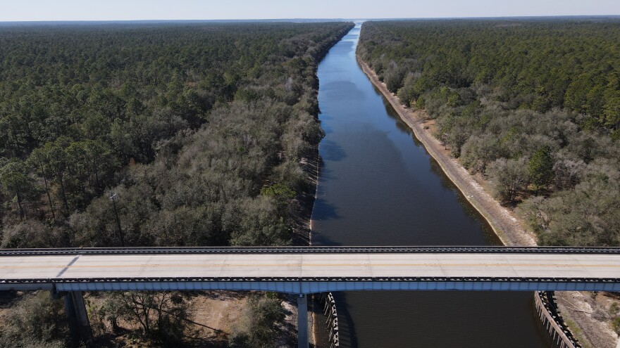 A section of the unfinished Cross Florida Barge Canal is visible beneath a bridge on State Road 19 south of Palatka, looking west toward the Rodman Reservoir.