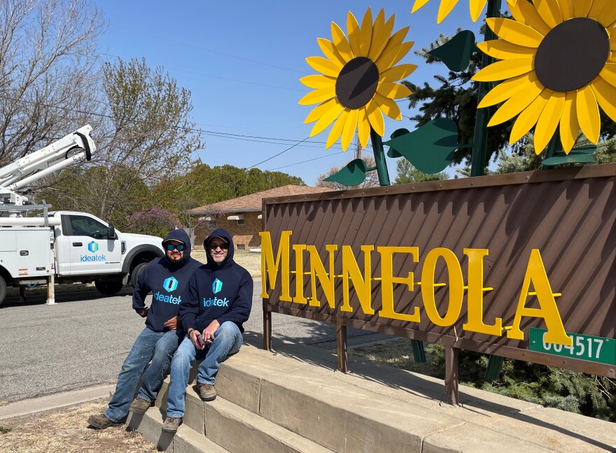 Ideatek employees John Osborn, right, and Jose Rios install fiber internet to the town of Minneola, population 738, last month. It's one of several small towns that have been recently connected to Ideatek's fiber line in southwest Kansas. (Photo courtesy of Ideatek)