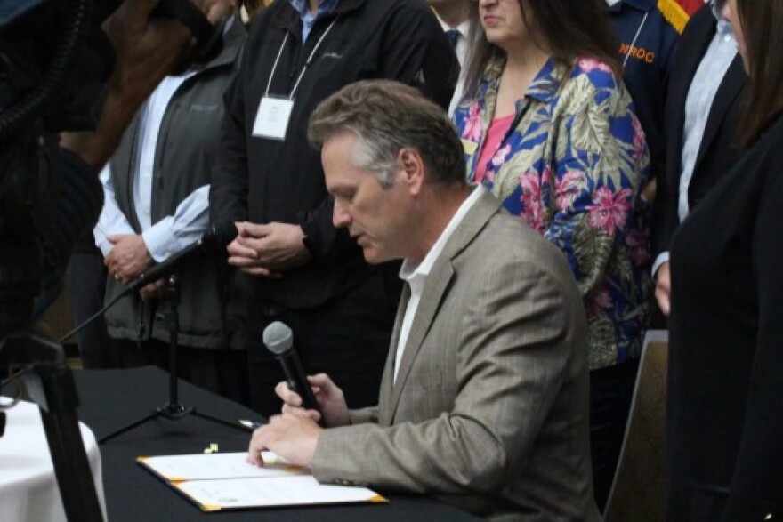 Gov. Mike Dunleavy signs a bill establishing an Alaska Office of Broadband to coordinate federal funds received by the state.