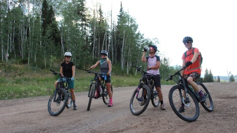 Members of the Girls Outside mountain biking group take a quick break during a ride on the Expresso trail near Snowmass Village on Aug. 4, 2026.