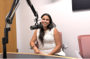 Dr. Javiera Monardez Popelka sitting behind a microphone in the WGLT studios.