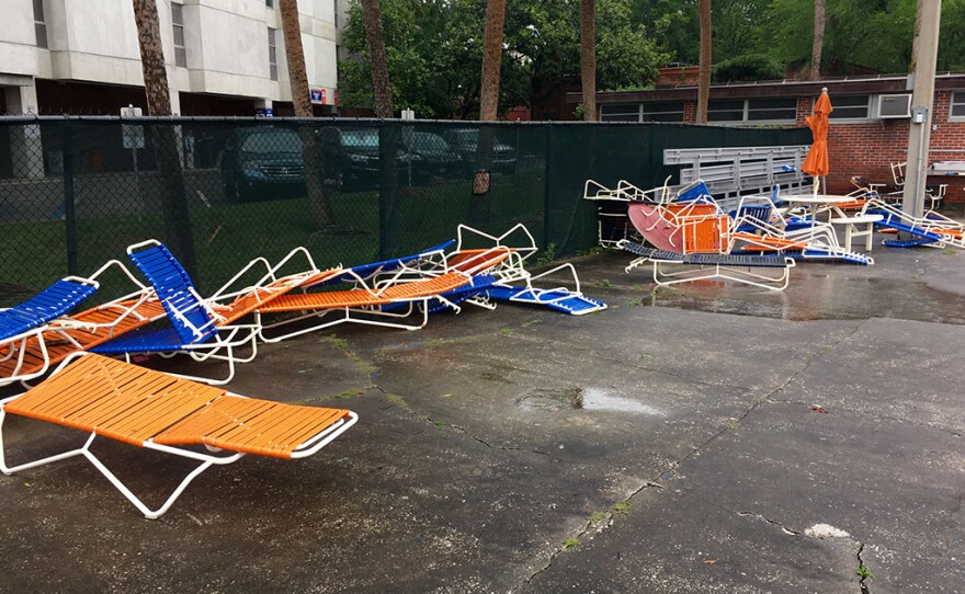 Pool chairs are strewn about after a thunderstom Friday at the Florida Pool, near Ben Hill Griffin Stadium (Photo courtesy of UF Department of Emergency Management).