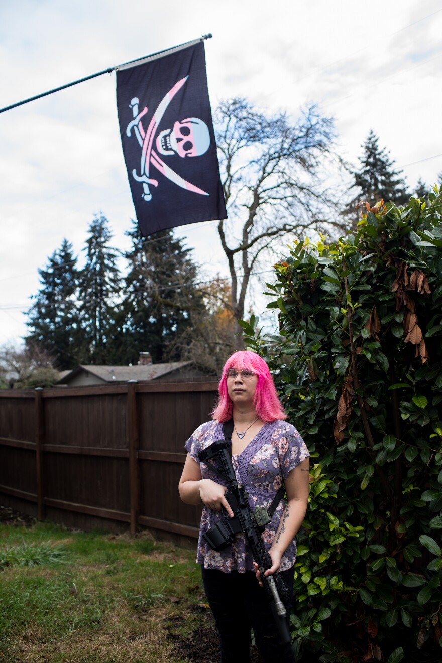 Mia Rose holds her custom built AR-15 in her home in Eugene, Ore.