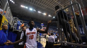 Florida's Dorian Finney-Smith shakes hands with fans on his way to the locker room at the team's Jan. 9 game against LSU. (File/WUFT News)