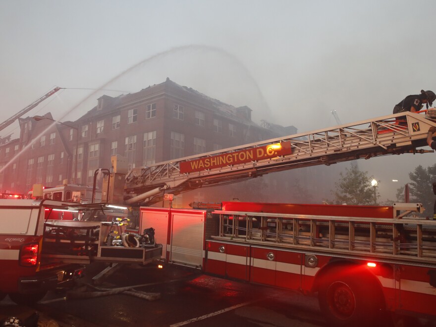 Firefighters pour water on a fire at the Arthur Capper Senior Building, an apartment building that houses senior citizens, Wednesday, on Wednesday.