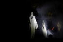Halloween ghost statues are seen in the park during a Halloween celebration in Vilnius, Lithuania. (Mindaugas Kulbis/AP)