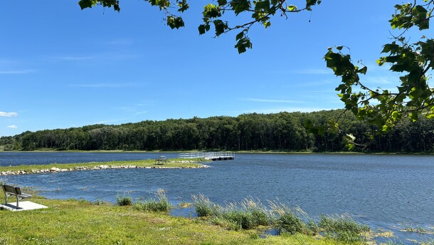  Blue lake is shown on a sunny day.