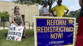 Members of the Elkhart County Democratic Party demonstrate before state lawmakers' public hearing on redistricting on Saturday, Aug. 7.