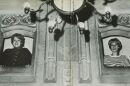 Four women peek out from a wall inside IU's campus