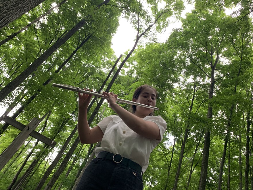 Playing the flute in the forest