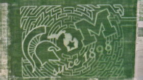 A birds-eye view of the 12 acre corn maze located at Choice Farm Market in Webberville, Mich. The maze has both the Michigan State Spartan helmet and the University of Michigan Block M etched into the the design with the an outlive of Michigan at its center.