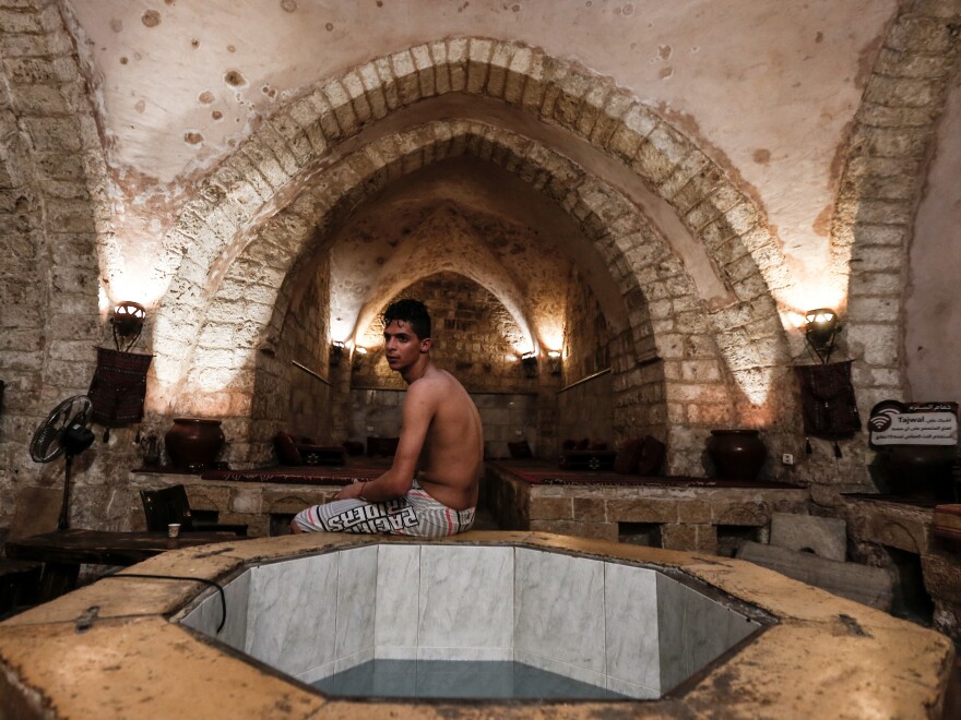 A Palestinian man relaxes at the ancient Samaritan Hammam, a traditional Turkish steam bath, in Gaza City, on March 3, 2021.