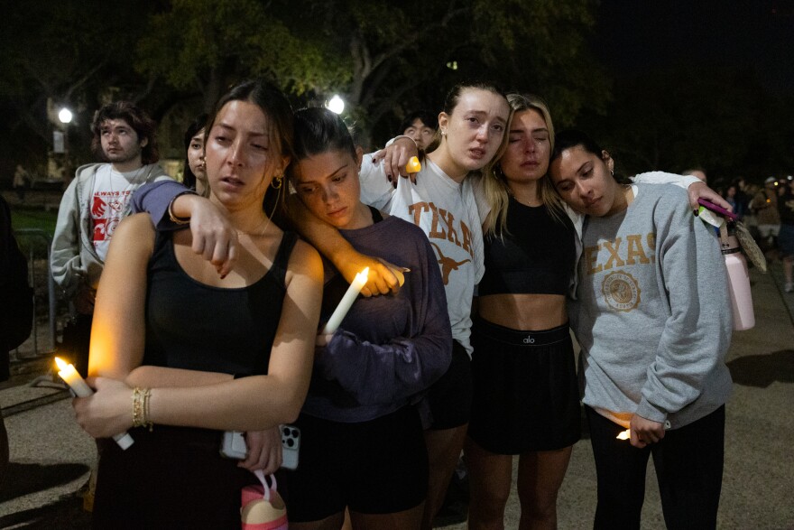 A group of students hold each other during a candlelight vigil held on the UT campus.