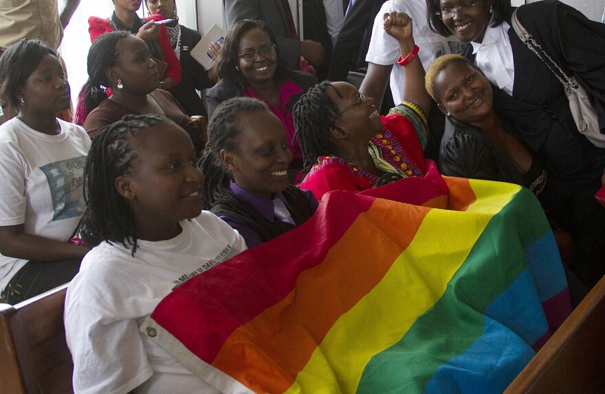 Members of Uganda's gay community and gay rights activists react after the constitutional court overturned an anti-gay law.