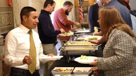 Diego Morales, left, goes through the line at a staff Thanksgiving meal costing $3,000.