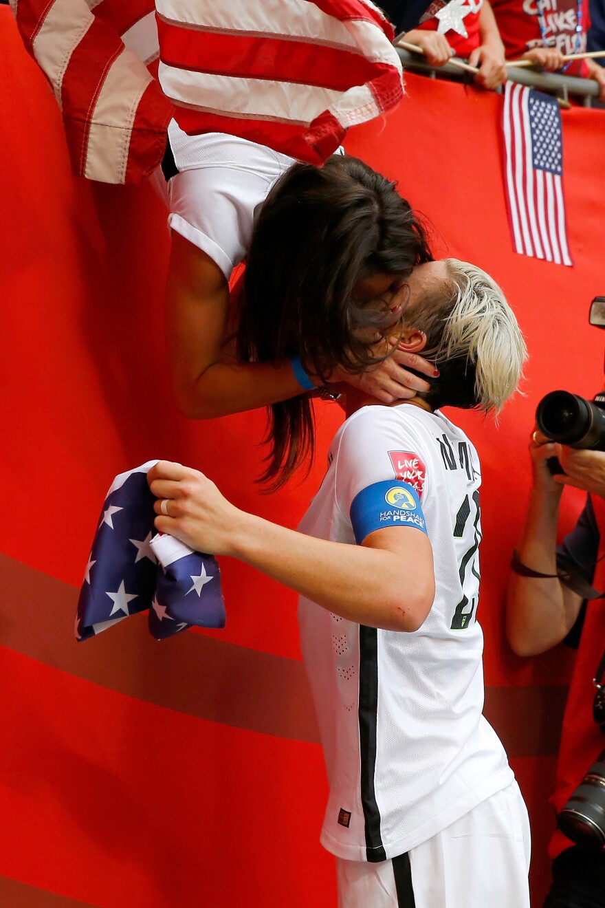 "Little did we know that it would go viral," Wambach says of the now-iconic image of her kissing Sarah Huffman at the 2015 World Cup.