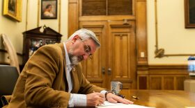 Indiana Gov. Eric Holcomb signs bills into law in a photo taken March 7, 2022.