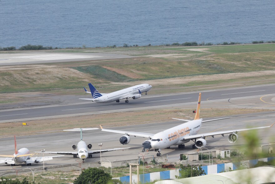 A COPA Airlines plane takes off at Simon Bolivar International Airport in Maiquetia, Venezuela, Monday, Dec. 1, 2025, days after the government revoked operating rights for international airlines that suspended flights following a warning from the U.S. Federal Aviation Administration.