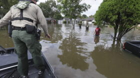U.S. Border Patrol Agent Steven Blackburn, left, checks if people wading in water need help during a search a rescue operation in a neighborhood inundated by floodwaters from Tropical Storm Harvey in Houston, Texas, Wednesday, Aug. 30, 2017. (LM Otero/AP)