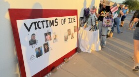 San Luis artist Emilia Verdugo places American flags on an altar for people killed by ICE officers since 2025 before a community vigil in Yuma on Wednesday, July 15, 2026.
