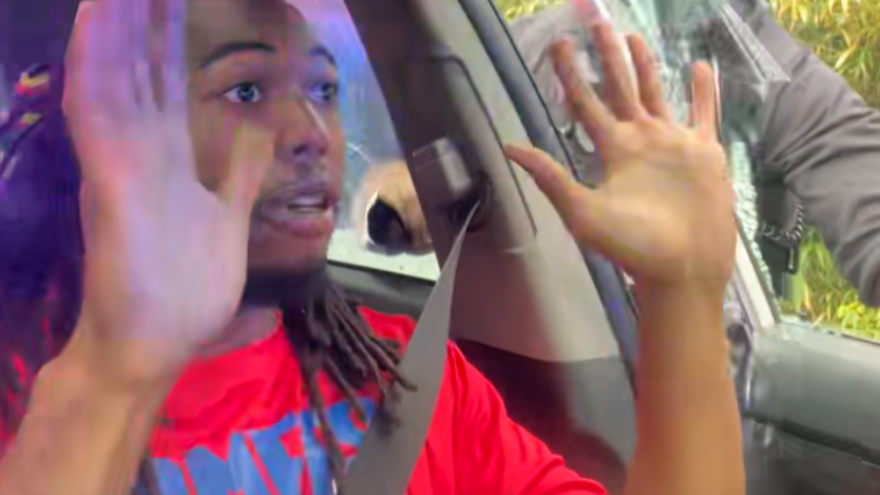 In this image take from video from what appears to be Will McNeil's X account (@904will), McNeil holds his hands up when asked by deputies before he is pulled from his vehicle and arrested on July 19, 2025.