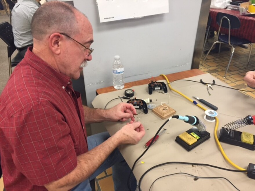 Dave Dalpiaz adapts a toy at CSU's Replay for Kids workshop (photo: Elizabeth Miller)