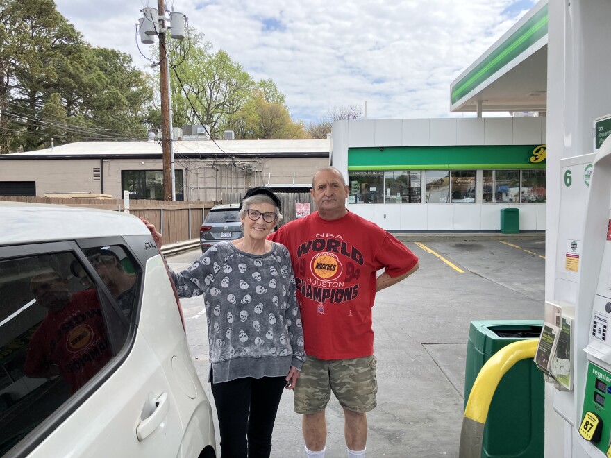 A couple prepare to fuel their car